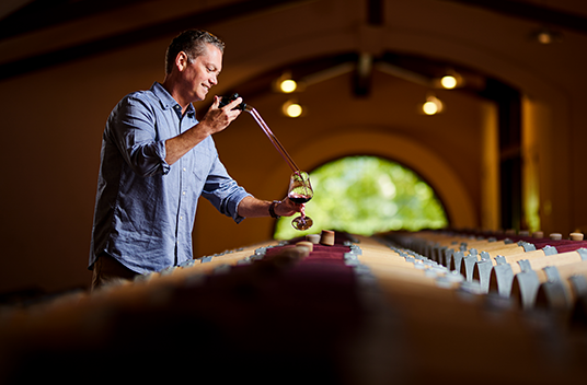 Groth Director of Winegrowing Ted Henry draws a barrel sample of Cabernet Sauvignon.